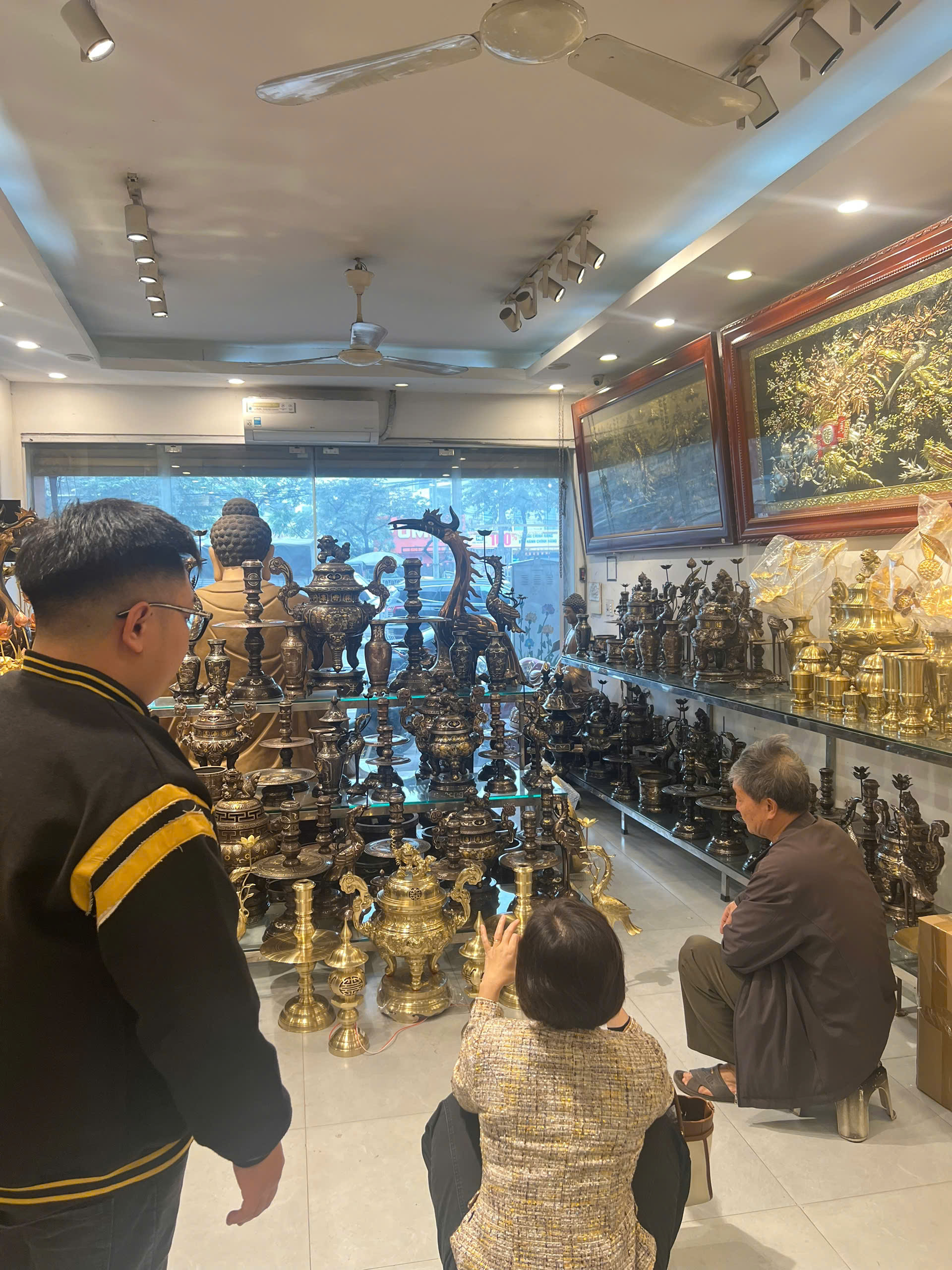 Khách hàng tới showroom tham khảo bộ ngũ sự song long bằng đồng catut